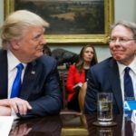 Trump and LaPierre smile at each other